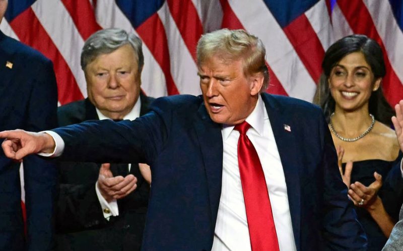 Former US President and Republican presidential candidate Donald Trump gestures at supporters after speaking as he holds hands with former US First Lady Melania Trump during an election night event at the West Palm Beach Convention Center in West Palm Beach, Florida, early on November 6, 2024. Republican former president Donald Trump closed in on a new term in the White House early November 6, 2024, just needing a handful of electoral votes to defeat Democratic Vice President Kamala Harris. (Photo by Jim WATSON / AFP)